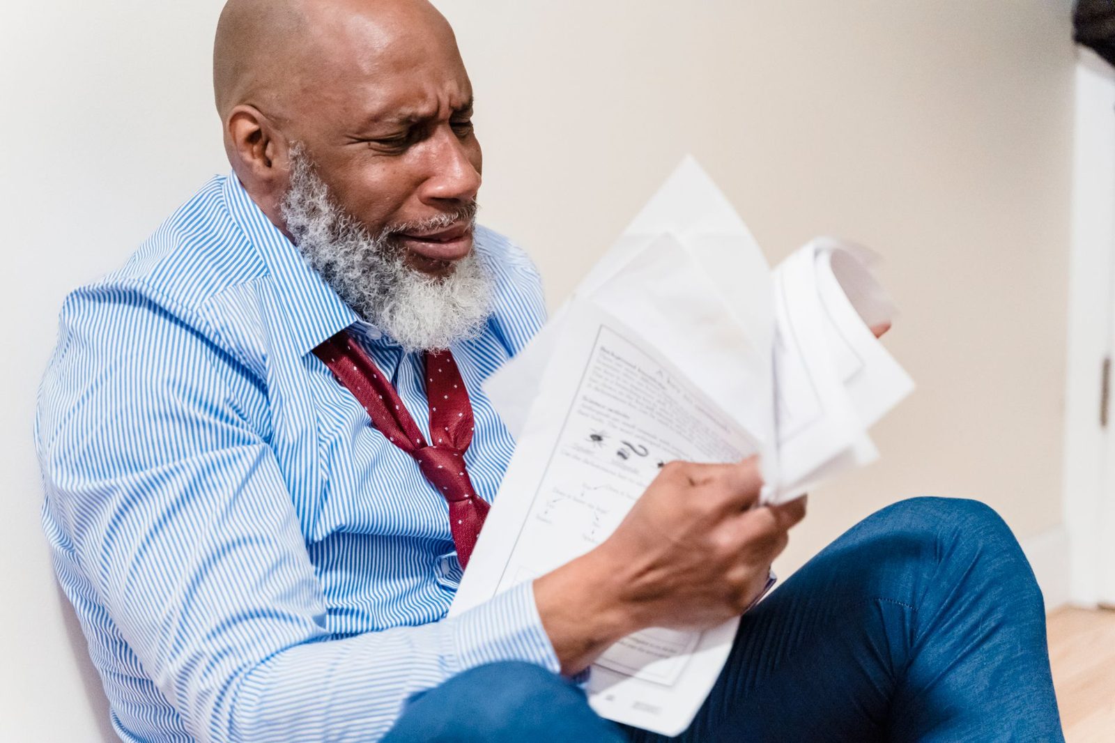 Man reading paperwork with a worried expression