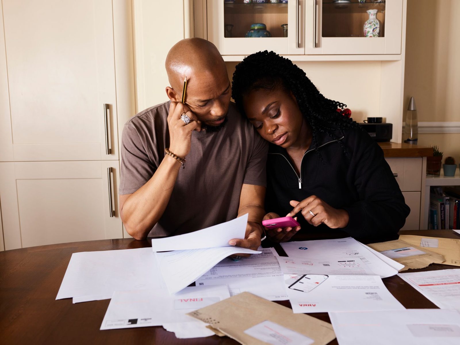Couple going through bills together at a table