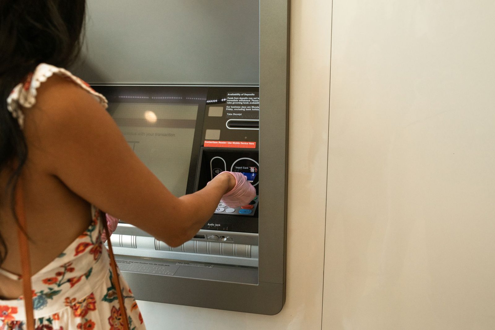 Hand using a cash machine